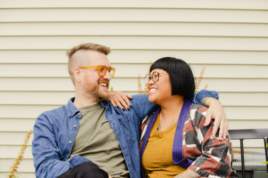 Man and woman sitting on bench smiling (photo courtesy of Comcast)